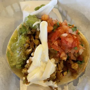 Taco - chicken, cheese, avocado, beans, sour cream and pico de Gallo. So juicy and flavorful