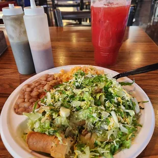 Chicken taquitos with guacamole, rice and beans combo. And a strawberry refresca drink