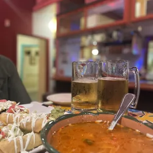 Tall glass beers, chicken Taquito and fideo