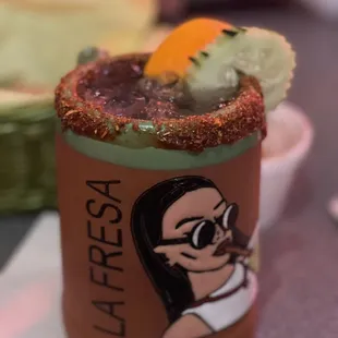 a bloody drink with a woman&apos;s face on it