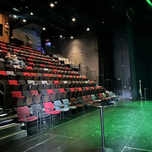 empty seats in a theater with green lighting