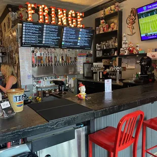 a bar with red chairs