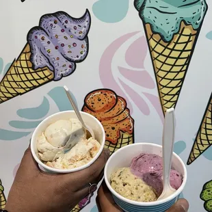 two people holding ice cream cones