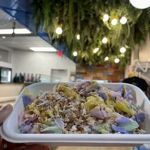 a person holding a bowl of food