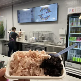 a person holding a container of food