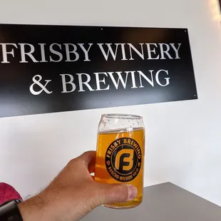 a man holding a pint of beer