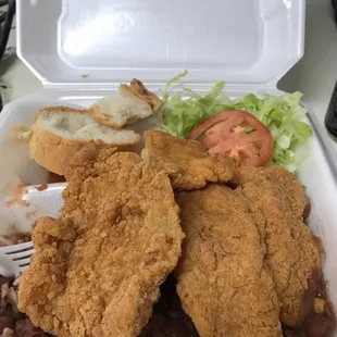 fried chicken and beans in a styrofoam container