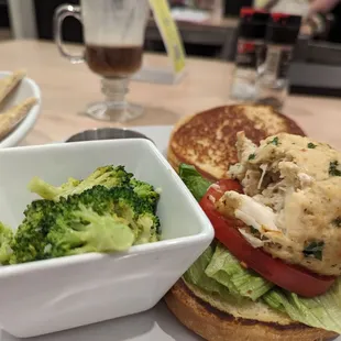 a sandwich and a bowl of broccoli