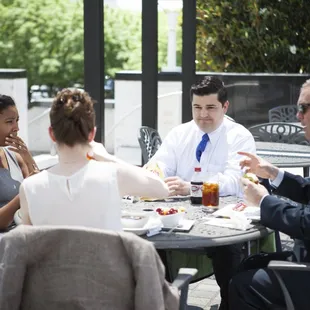 a group of people sitting around a table