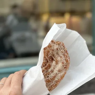 a hand holding a pastry