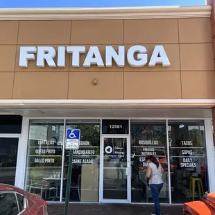 a woman standing in front of a store