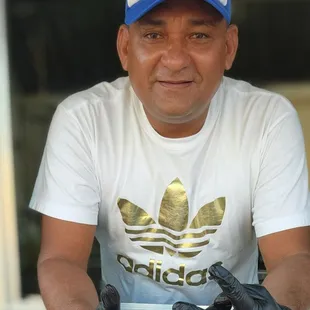 a man in a white t - shirt and black gloves