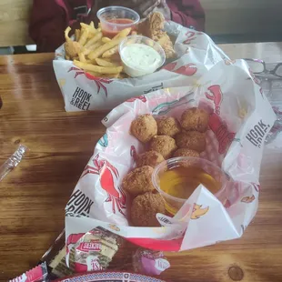 Fried catfish and hush puppies with french fries.
