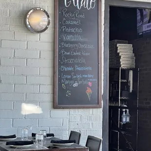 a chalkboard on the wall of a restaurant