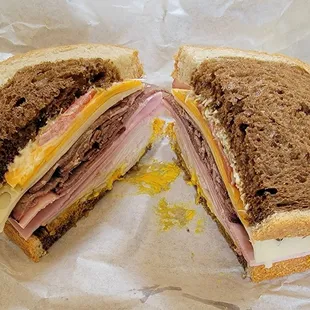 Lucifer - Roast beef, ham, turkey, Swiss, cheddar, sprouts, and tomatoes on rye bread. Delicious!