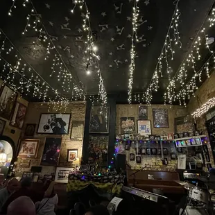 the ceiling decorated with christmas lights
