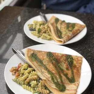 Classic Crepe with avocado added and a side of pasta, split in 2