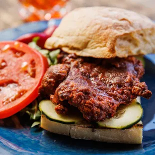 BUTTERMILK CRISPY CHICKEN
SANDWICH - Lunch Menu, crispy chicken in our signature Basquez sauce w/ pepino cucumbers and seasoned tomatoes