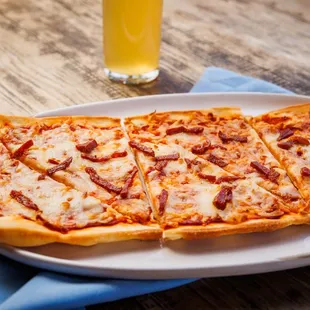 CATALONIAN CHORIZO FLATBREAD - Catalonian style flatbread topped with our brava tomato sauce, manchego mozzarella blend,
Spanish chorizo
