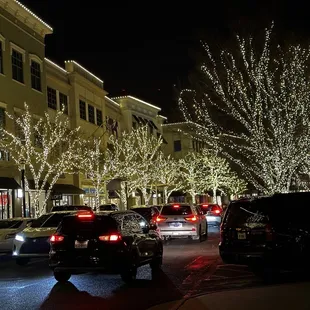 cars driving down a street at night