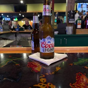 two beer bottles on a table