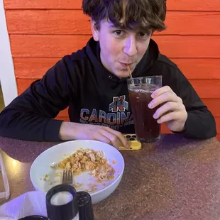 a boy drinking a beer