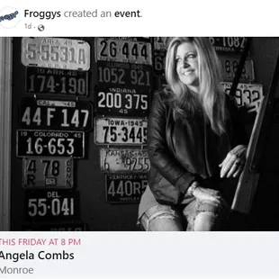 a black and white photo of a woman in front of license plates
