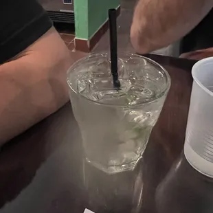 a glass of water with a straw