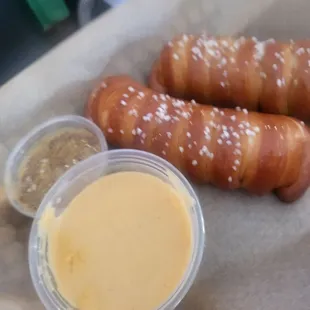 a basket of pretzels and mustard