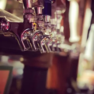 a row of beer taps