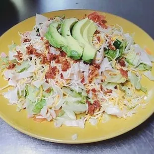 a plate of salad with avocado