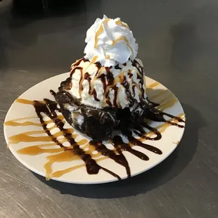 a desert with whipped cream and chocolate sauce
