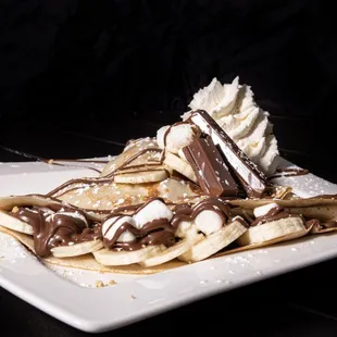 S&apos;mores in a crepe format. Nutella, Banana, Marshmellows, Kitkat, Graham Cracker. Yummm!!