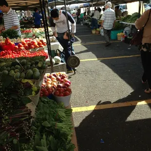 people shopping at a farmers market