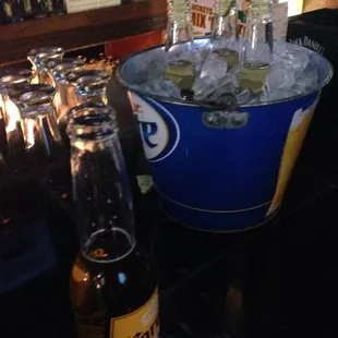 a bucket of ice and a bottle of beer