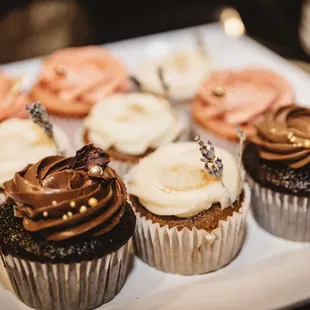 a plate of cupcakes with chocolate frosting