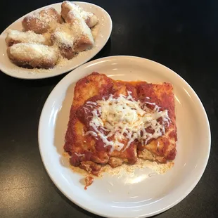 a plate of lasagna and a plate of donuts