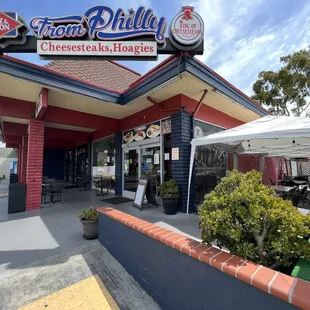 The outside of the restaurant and their outdoor seating area on the right.