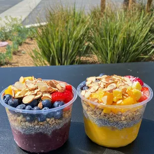 two bowls of fruit and yogurt