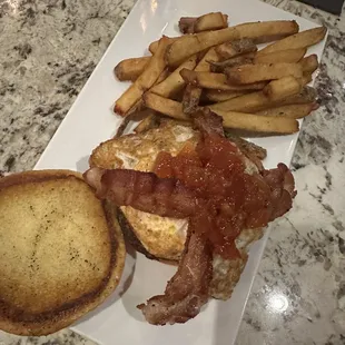 Blackened chicken sandwich with an egg and bacon