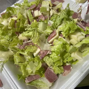 a salad in a styrofoam container