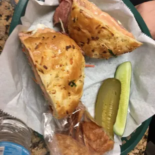 Corned beef on an onion roll with slaw and Russian dressing NEW and old pickle