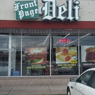 a car parked in front of a deli