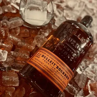 a bottle of bullet bourbon on ice