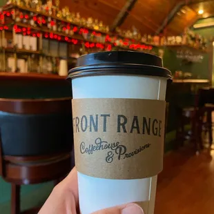 a hand holding a coffee cup