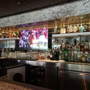 a bar with many bottles of alcohol