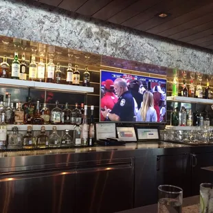 a bar with a television on the wall