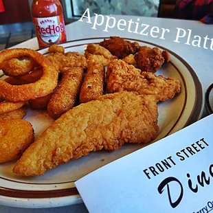 a plate of fried chicken and onion rings