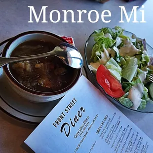 a bowl of soup and a plate of salad