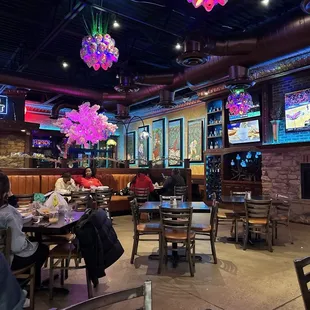 people sitting at tables in a restaurant